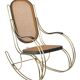 Modernist rocking chair in gilded brass and cane.