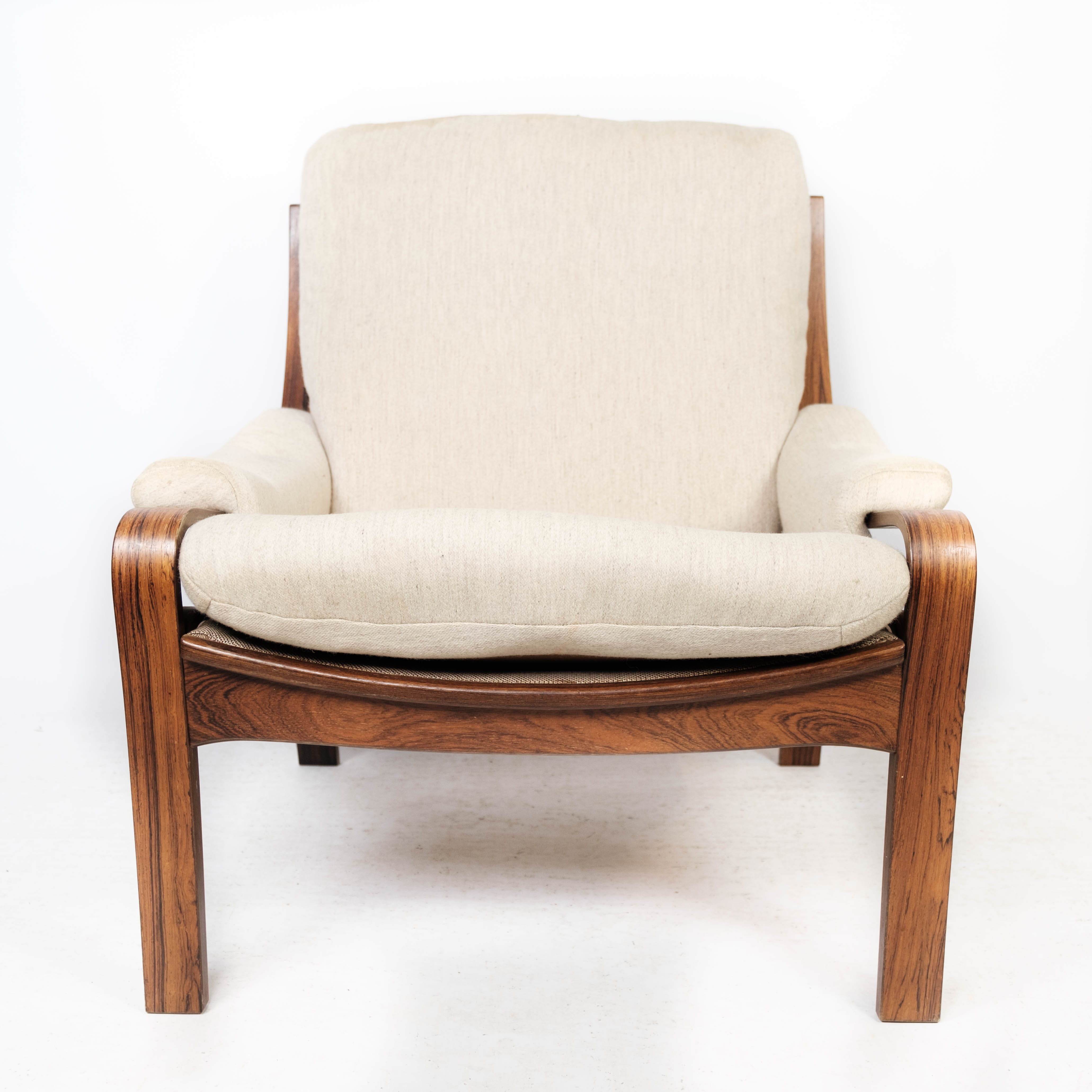 Armchair in rosewood and upholstered with light fabric, of Danish design, 1960s