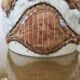Ceramic lamp with double lighting and openwork design.