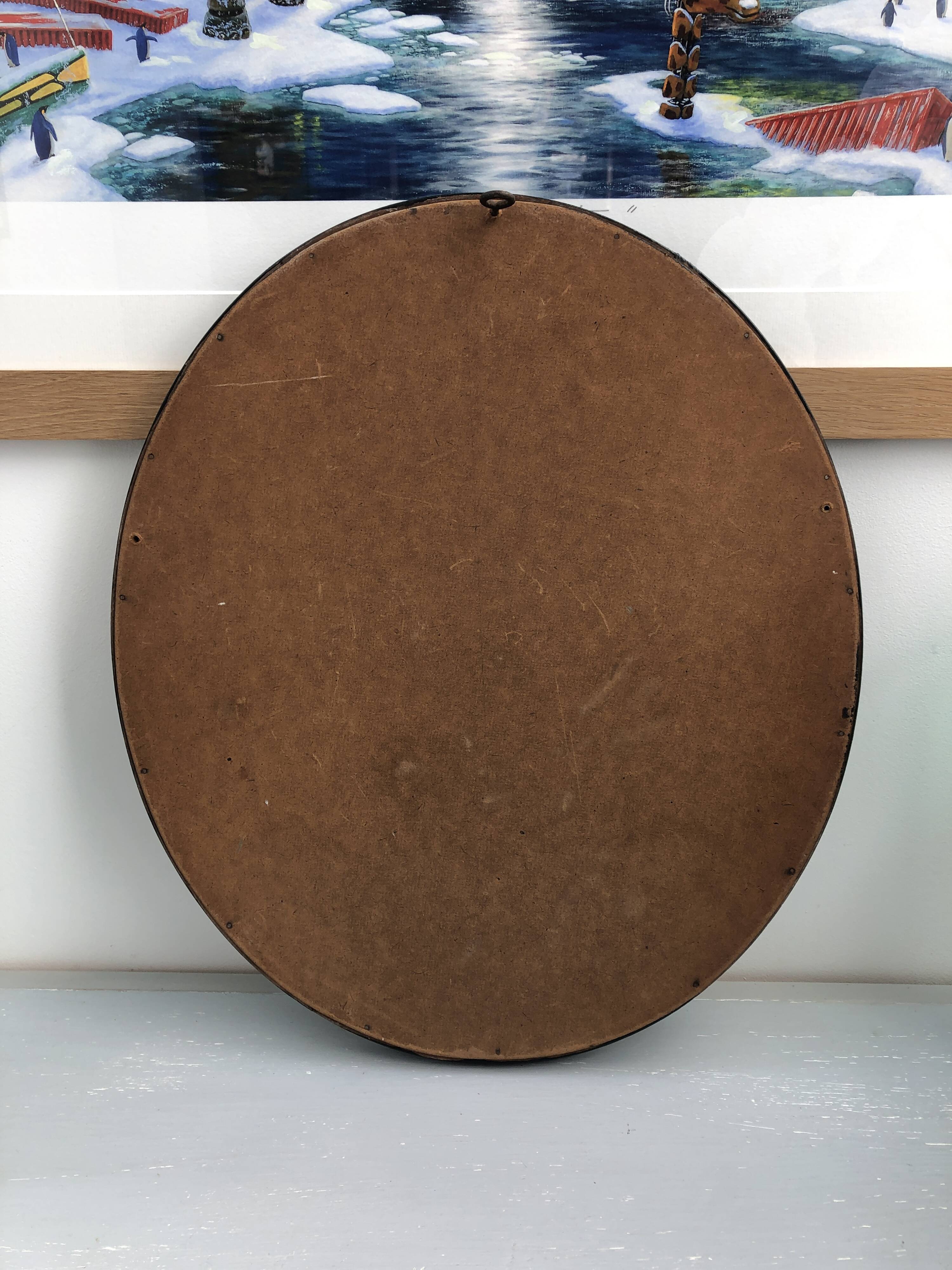 black and gold oval mirror