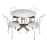Antique painted wrought iron garden furniture, round table and four chairs.