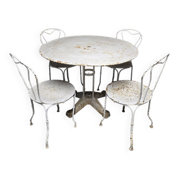 Antique painted wrought iron garden furniture, round table and four chairs.