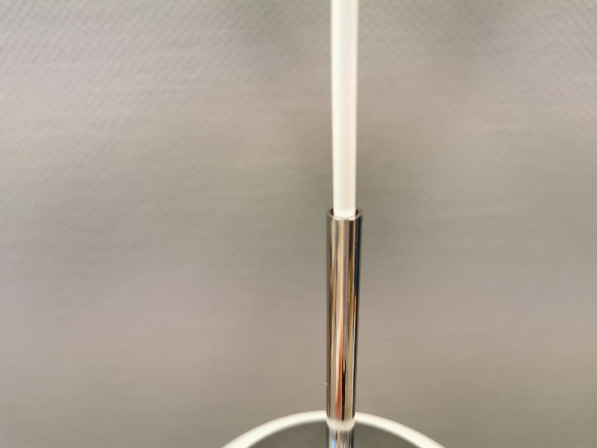 White hanging lamp with metal suspension, made with ball round opal glass shade.