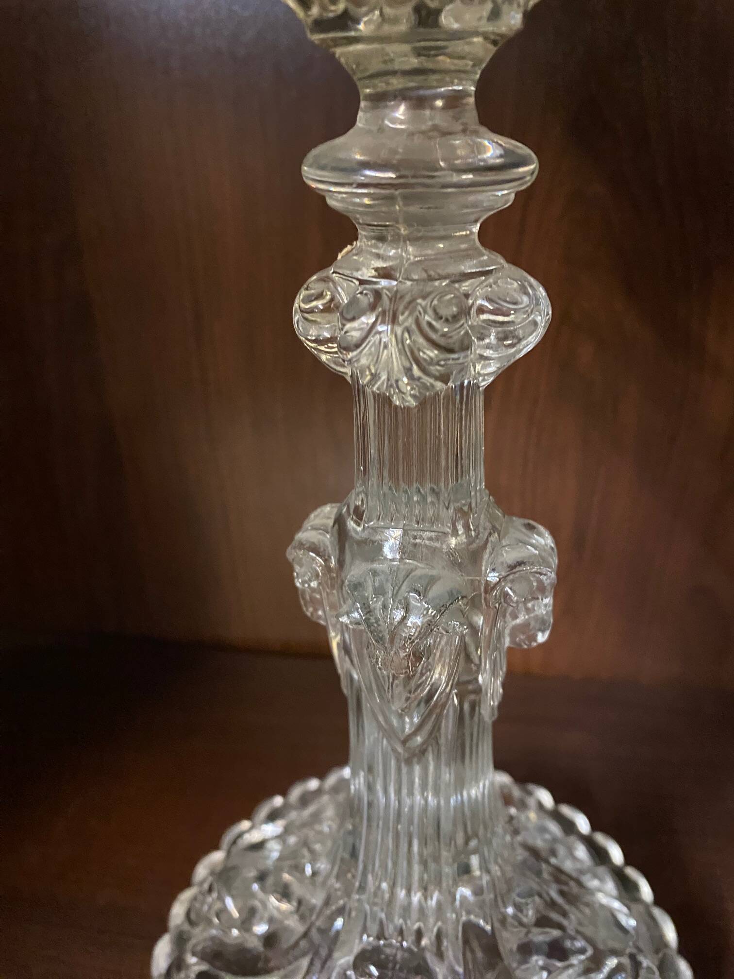 pair of cut glass candlesticks with lion and ram head decor, late 19th century