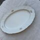 Large yellow porcelain serving dish by Bernadotte from the 1960s, with a gold rim and relief.