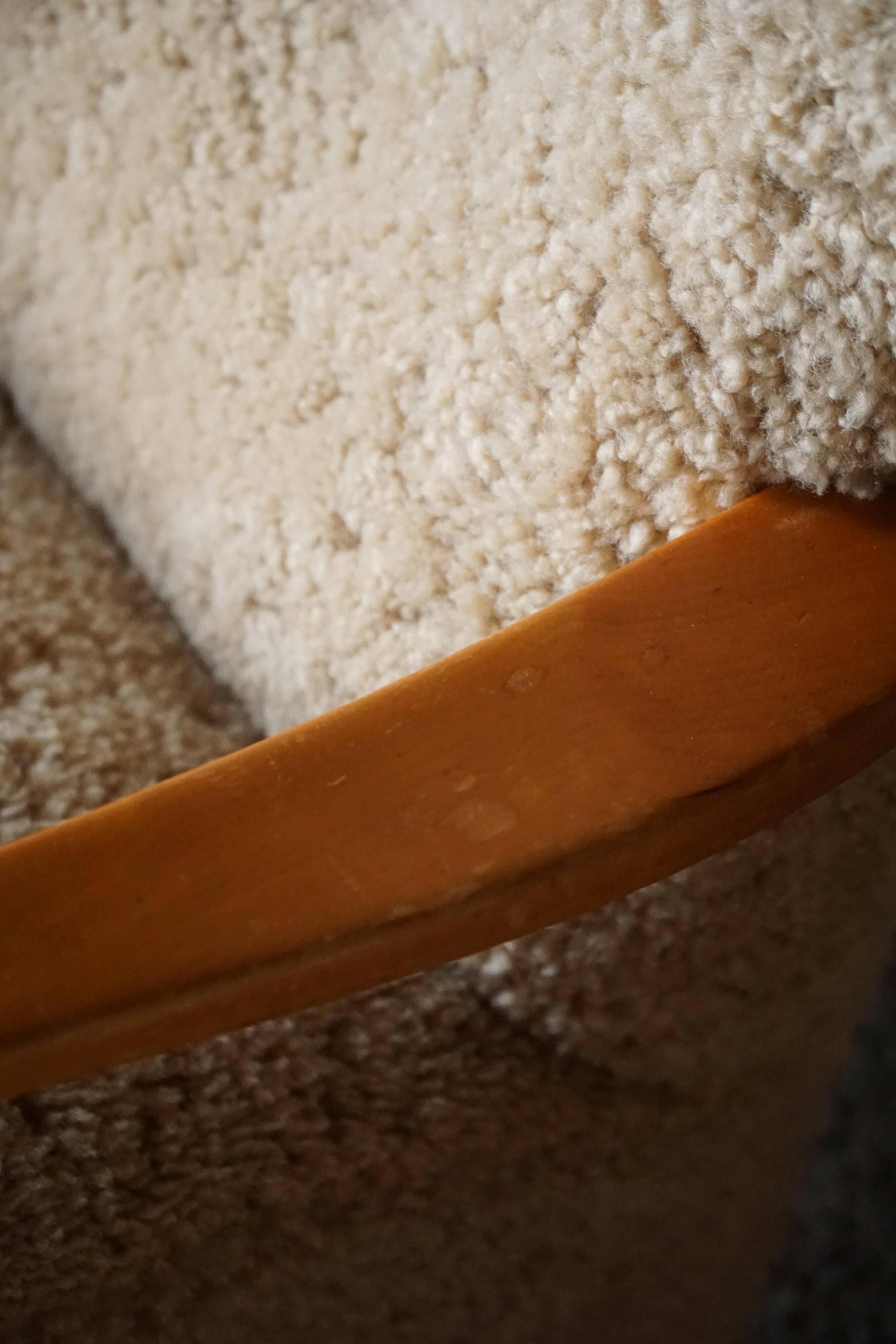 Pair of Mid Century Modern Swedish lounge chairs in birch and lamb's wool, 1960s.