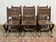 Suite de 6 chaises et 2 fauteuils en chêne et cuir à décor gothique