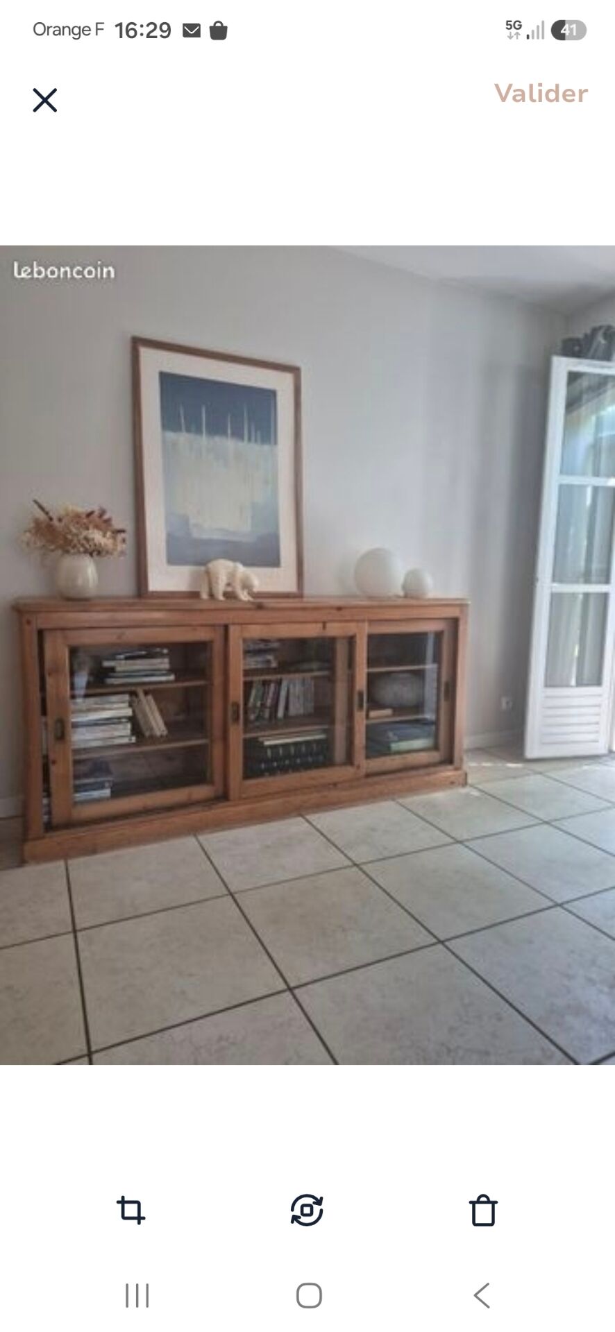 Antique wooden sideboard with three sliding glass doors.