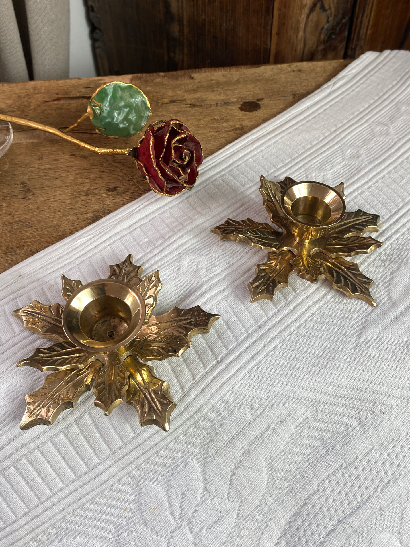 Pair of candlesticks, holly leaves, in brass