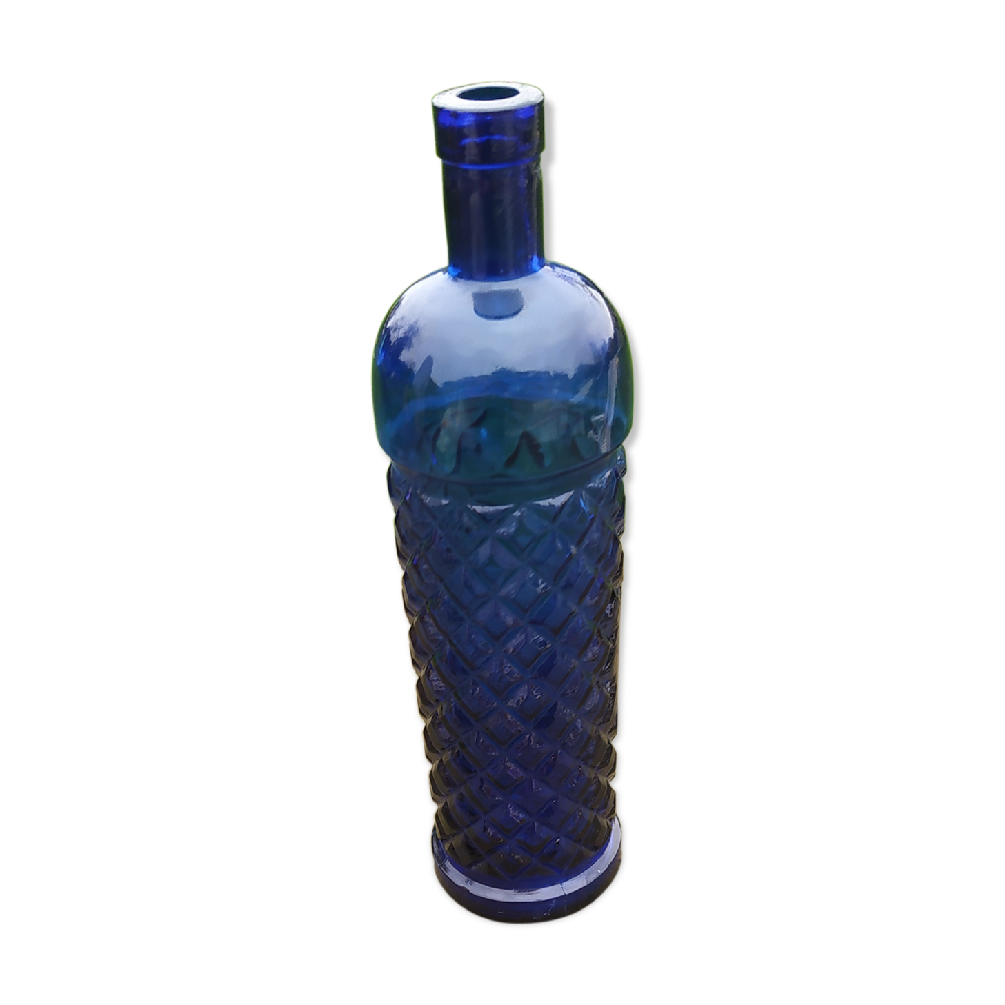 Vintage bottle in chiseled blue glass