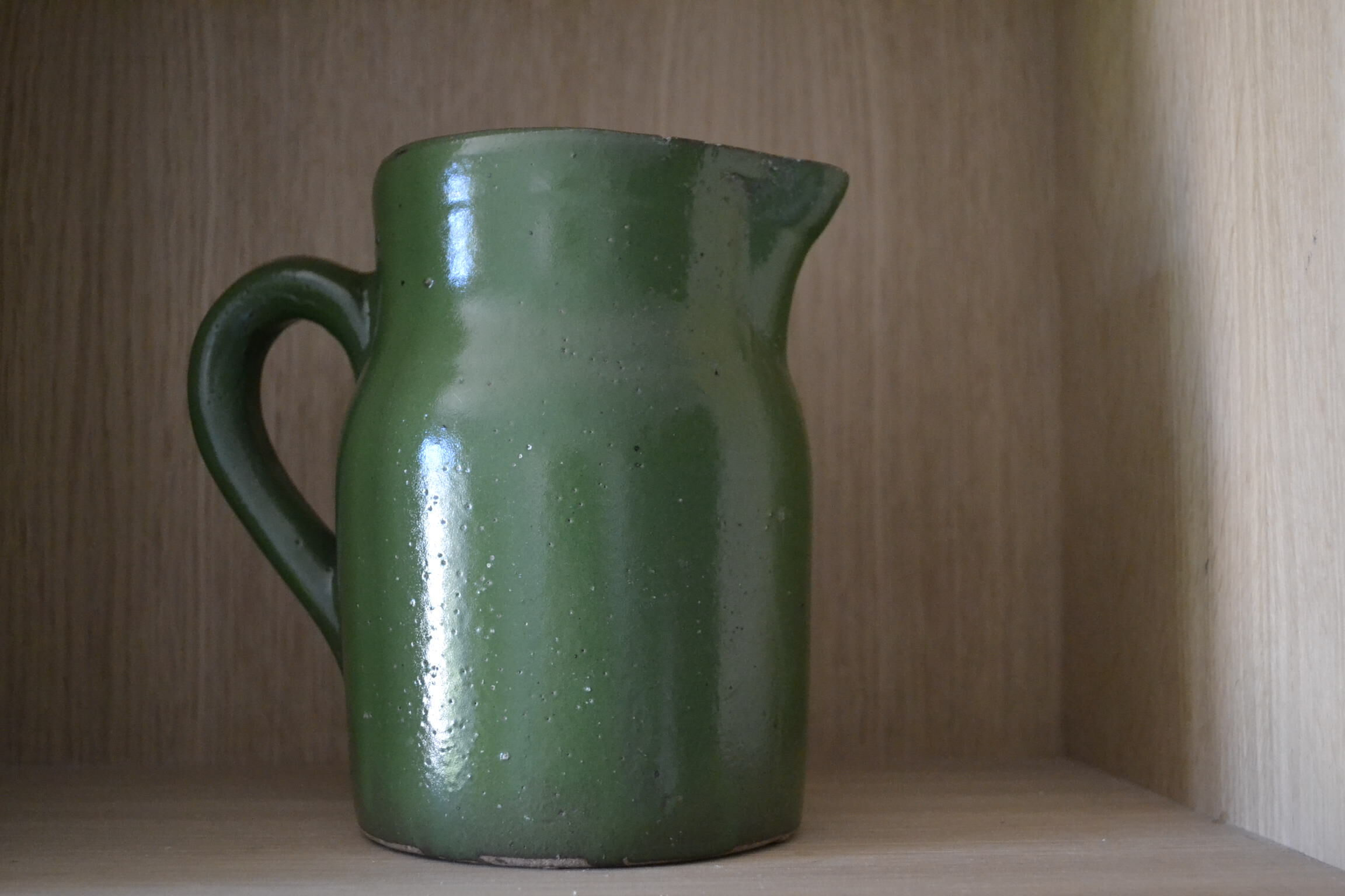 Green pitcher in sandstone