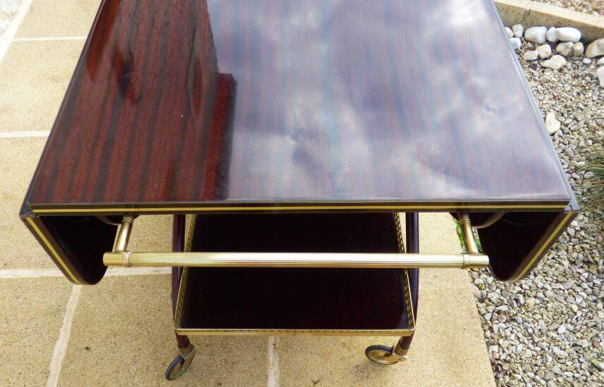 Chic serving table on wheels from the 60s with brass decorations and two shelves.