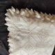 White cotton bedspread, crocheted sofa throw with star patterns