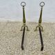 Pair of Neo-classical andirons, in solid bronze, 1920s-1930s.