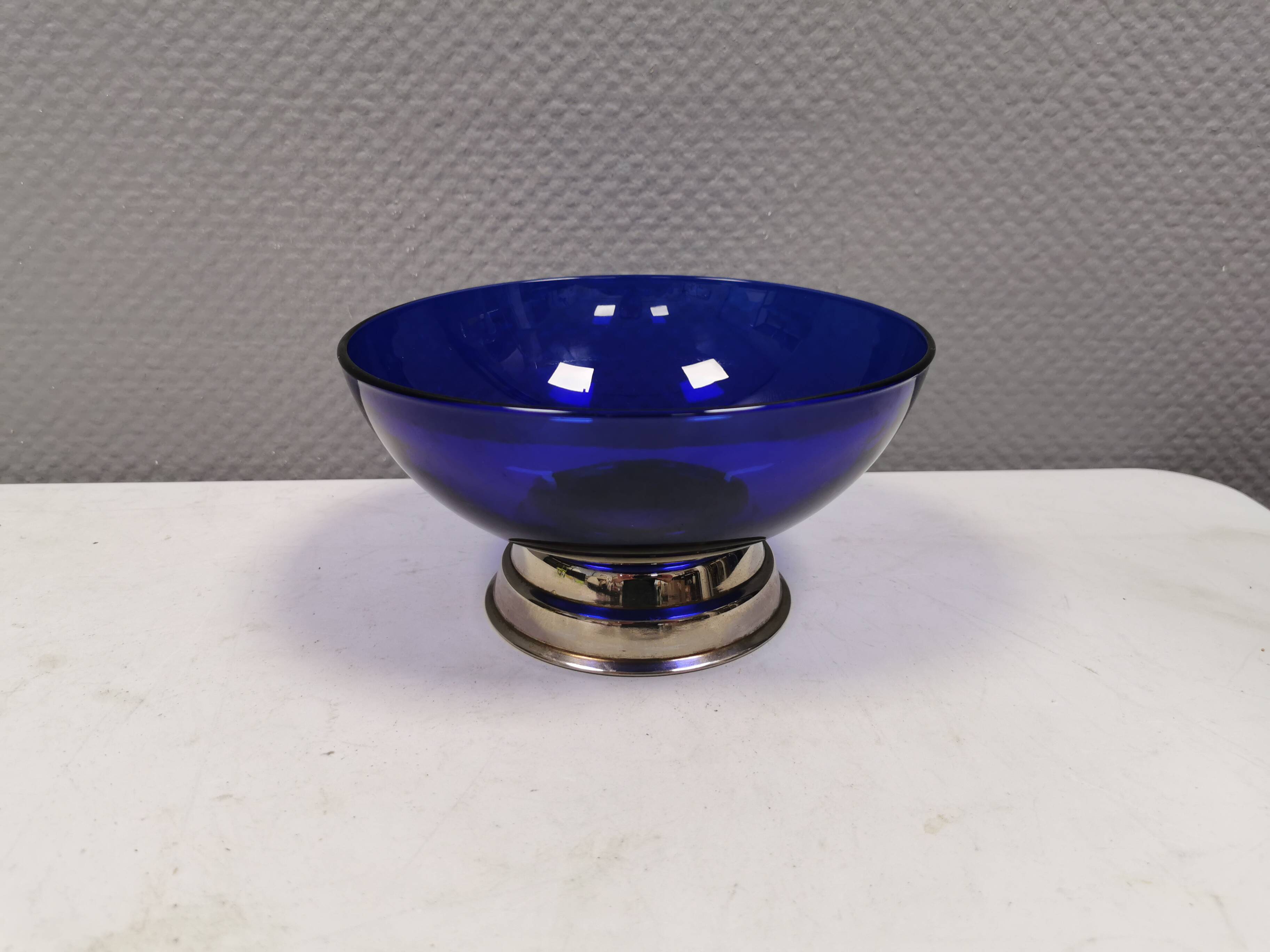 Beautiful blue glass bowl mounted on silver colored base (Original).