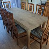 Set of 8 teak lounge chairs with high backs and zebra-striped seats