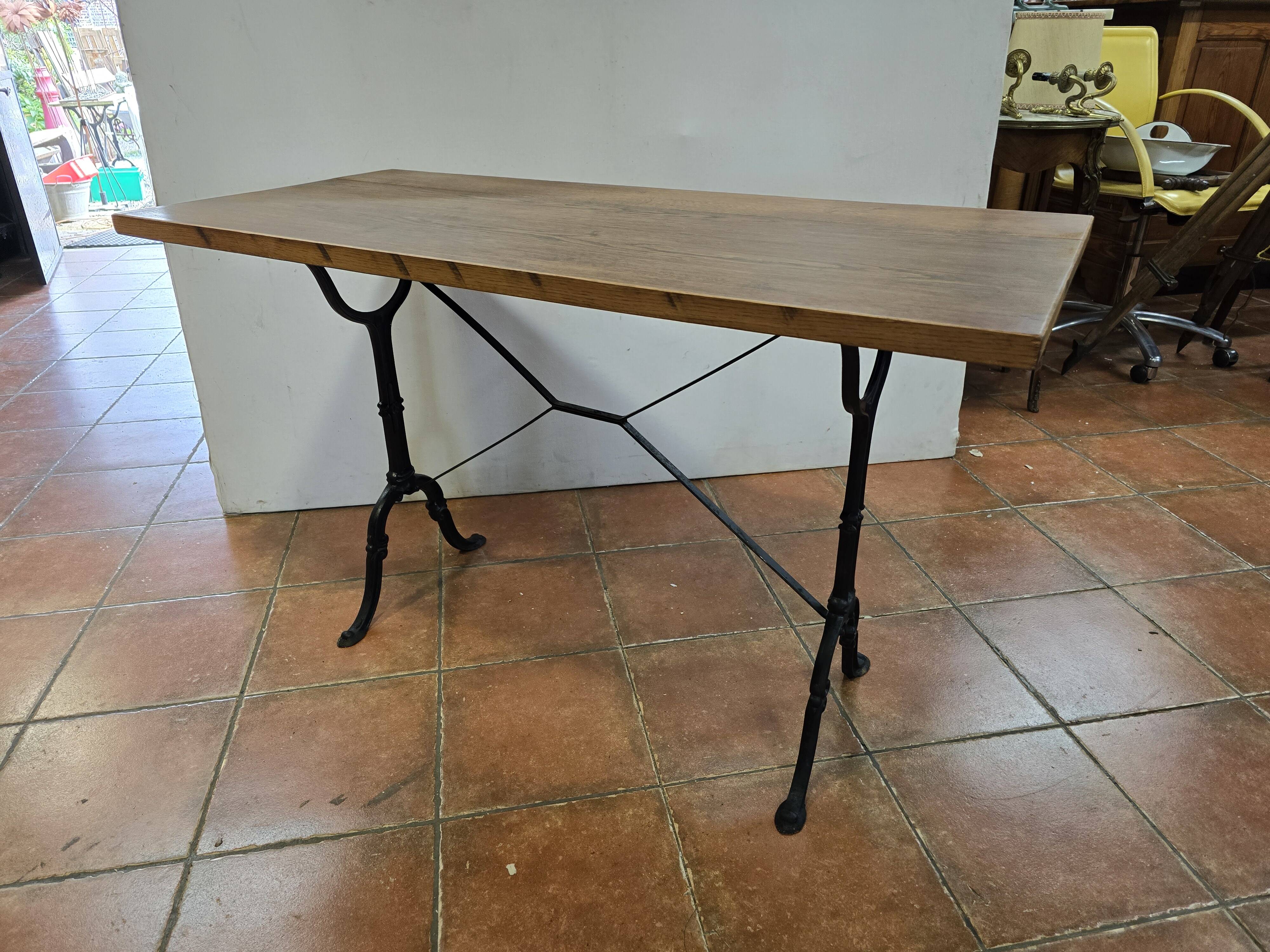 Old bistro table with oak top, cast iron base, 118 cm L
