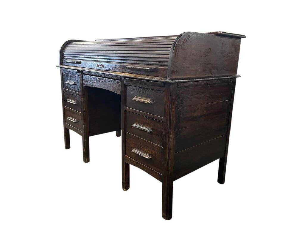 Vintage American wooden desk with a roll-top.