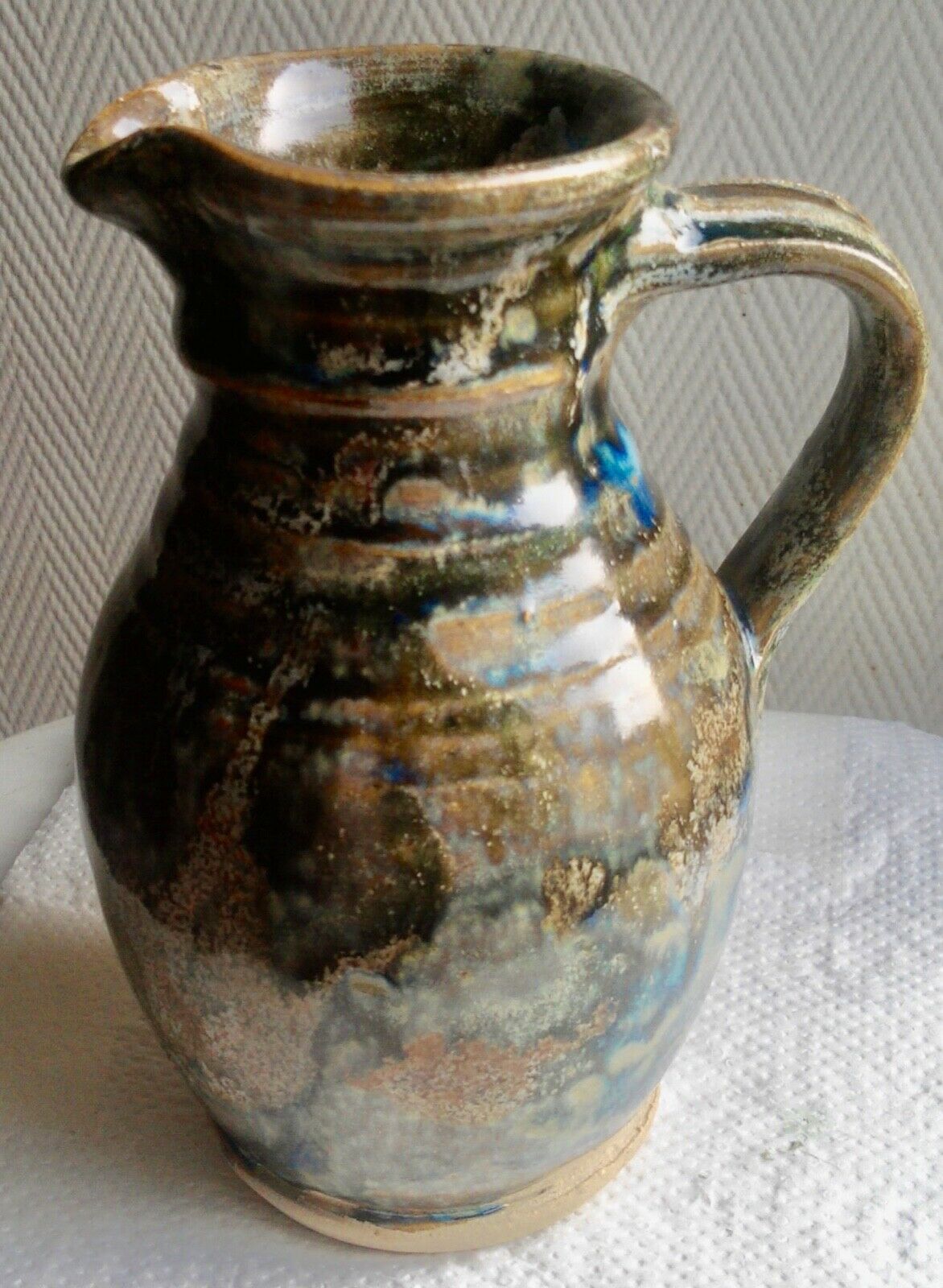 Enamelled ceramic pitcher, signature mb the terminal