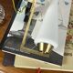 Vintage brass wall light with a white glass spindle shade from the 1950s-1960s.