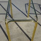 Nested tubular tables in gold metal.