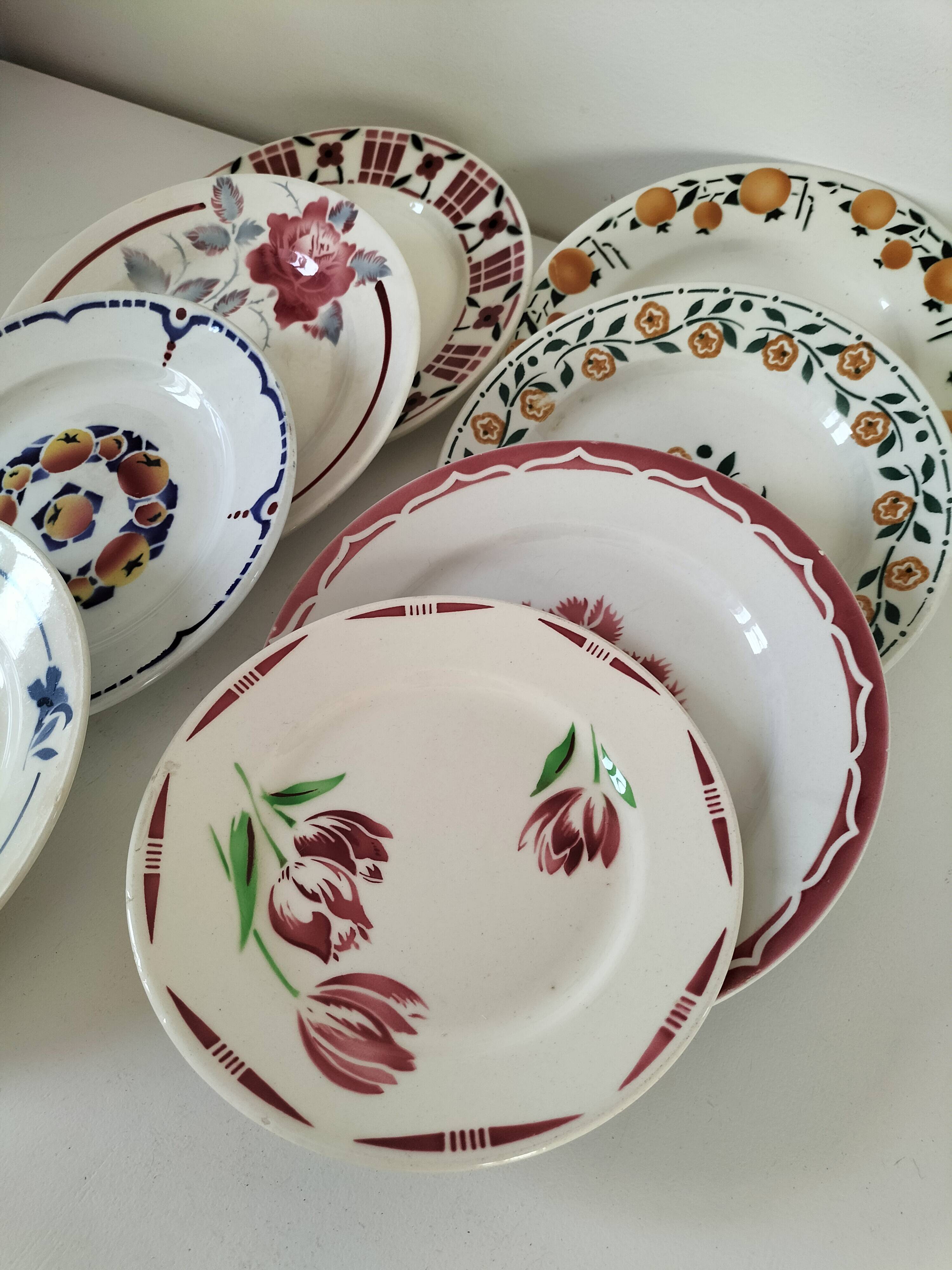 Set of 8 ironstone plates with coordinated designs.