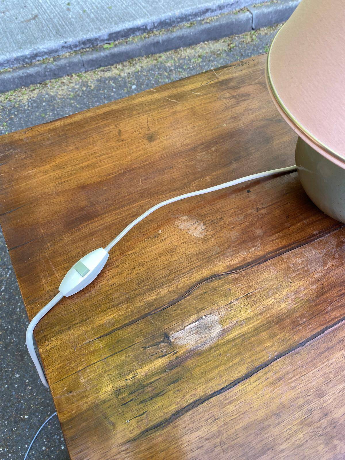 Vintage green ceramic bedside lamp with a pink-beige lampshade.
