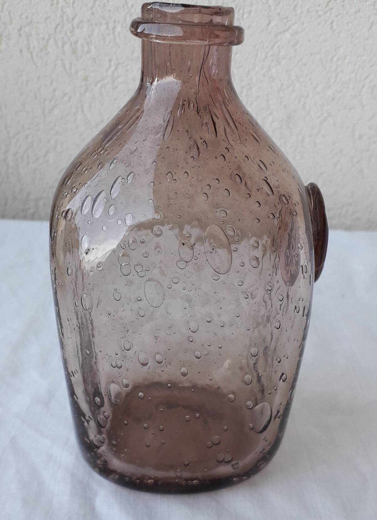 Biot bottle in bubbled glass