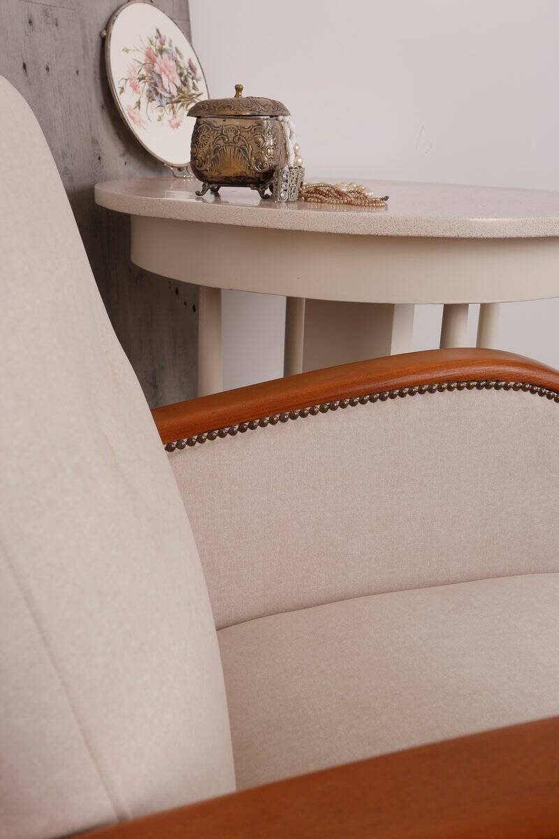 Art Deco armchair from the 1930s in beige fabric and carved wood, Hungarian origin.
