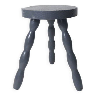 old three-legged stool in solid oak