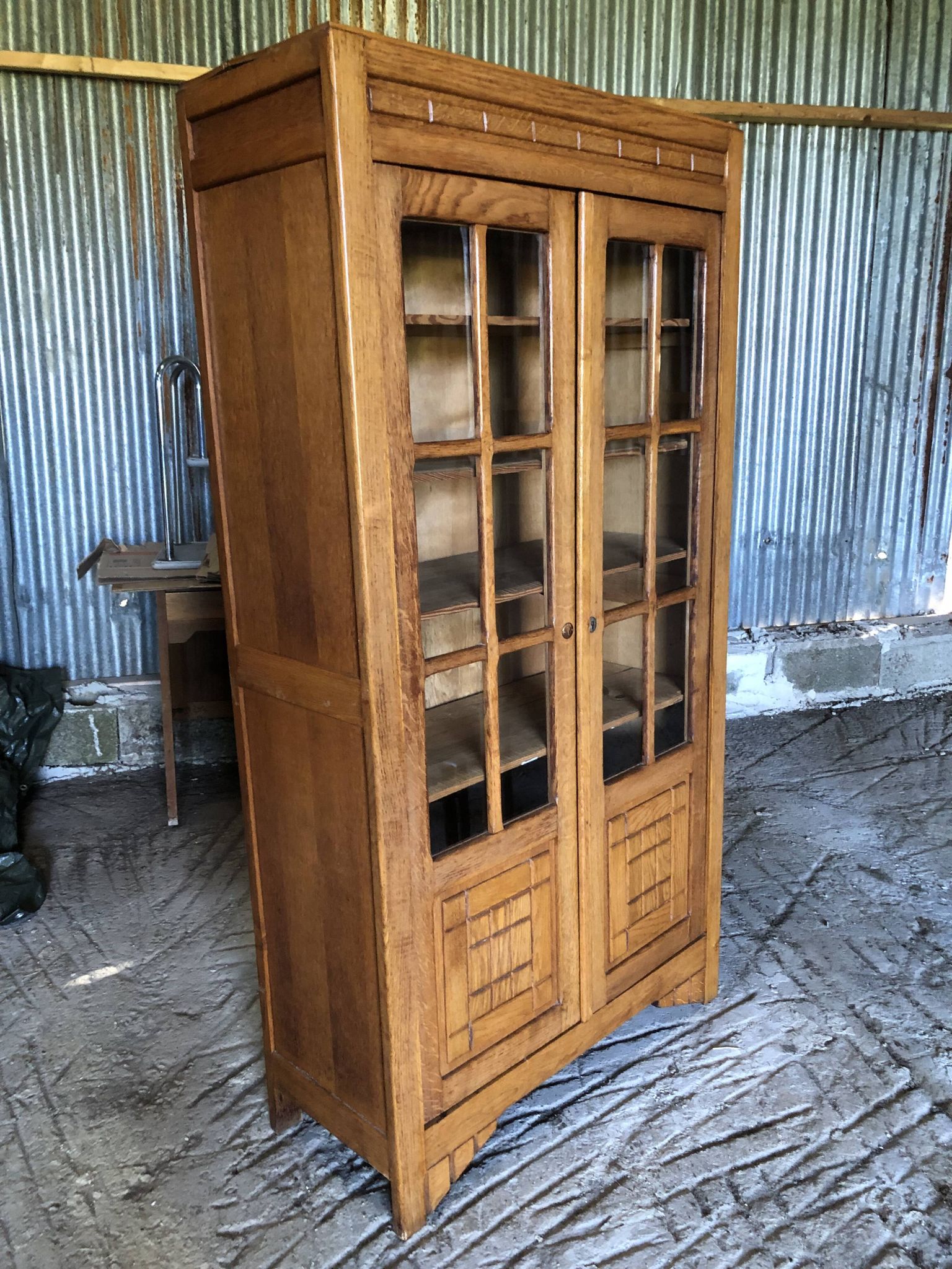 Vintage oak bookcase from the reconstruction period with 2 doors with small panes.