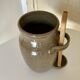 Old varnished stoneware pickle pot with tongs