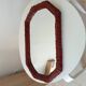 Vintage octagonal mirror in woven rattan.