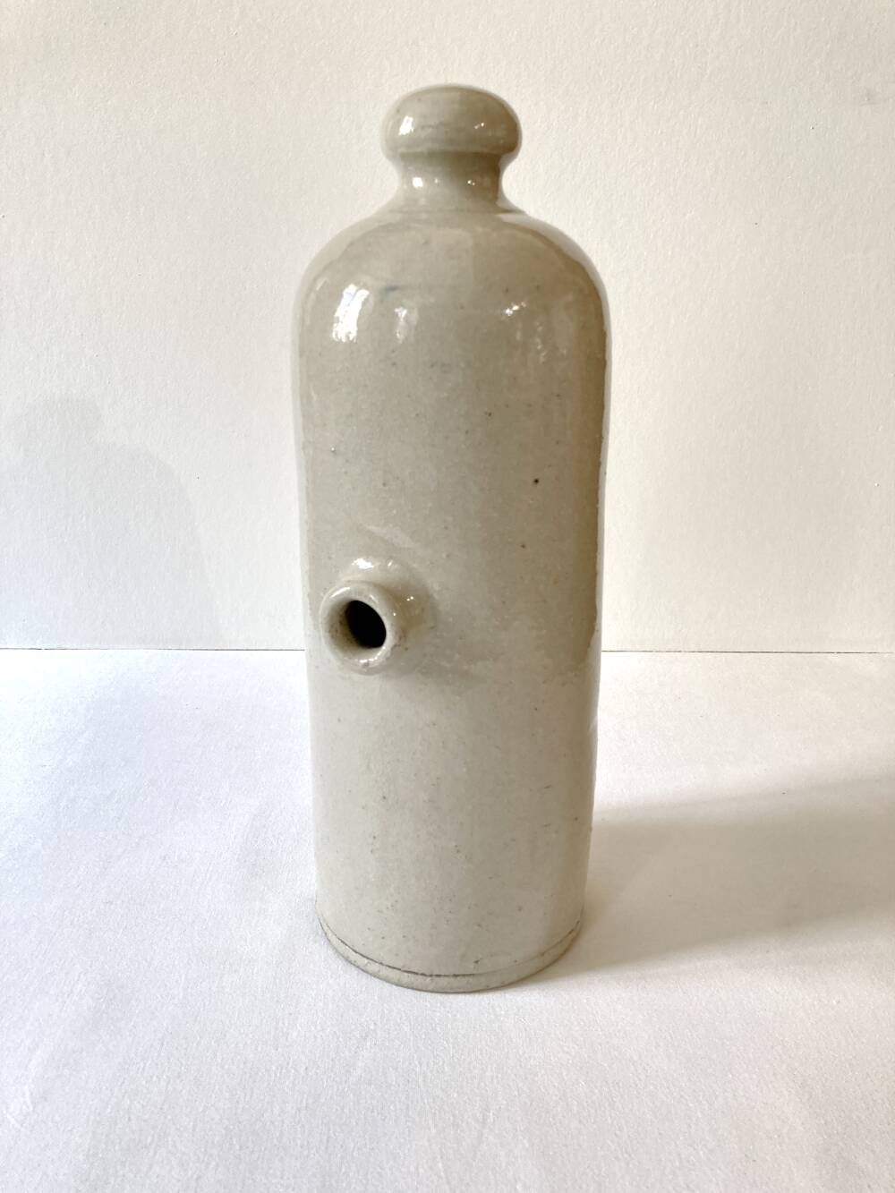 Old horizontal glazed stoneware hot water bottle, late 19th century.