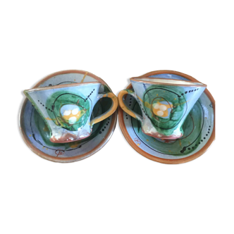 Two cups and their hand-painted ceramic saucer