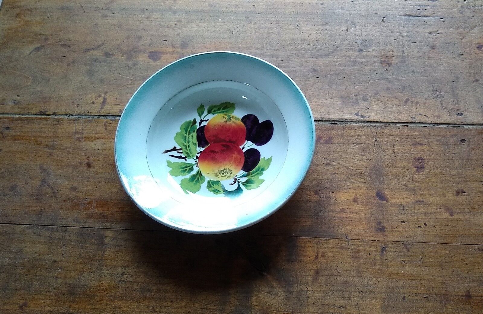 Round dish in Earthenware St Amand decorated with fruit apples and plums