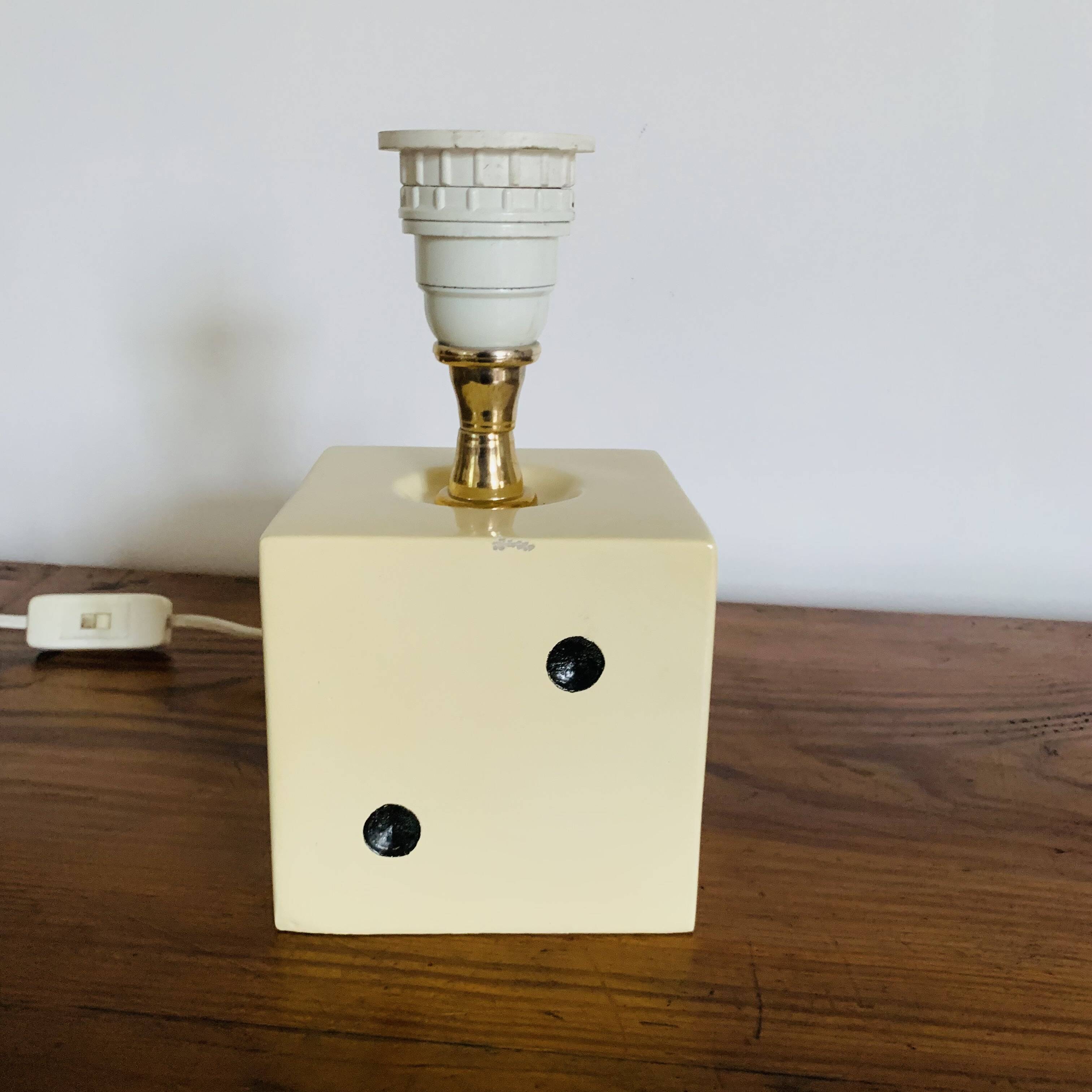 Lamp base representing a die
