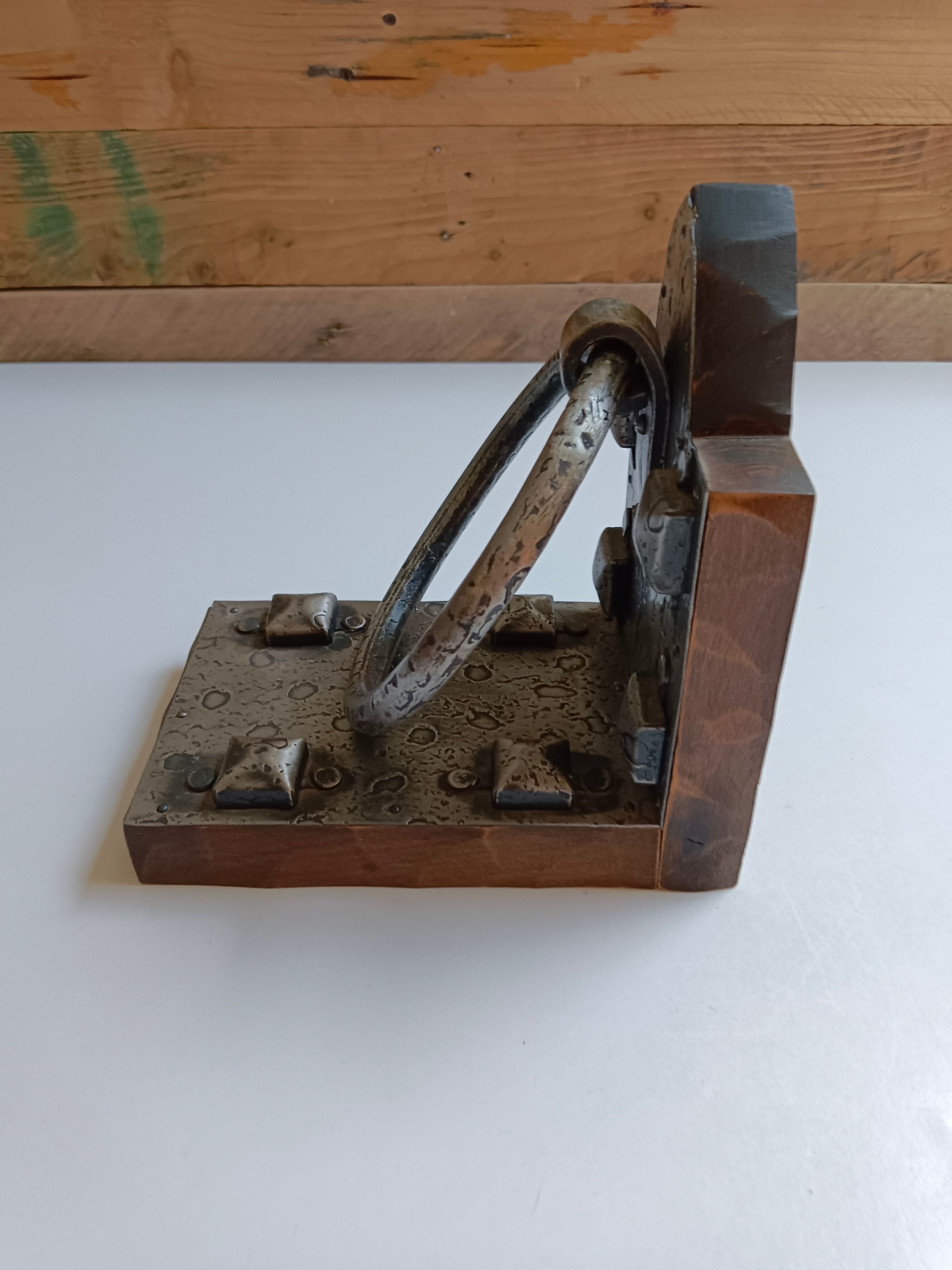 Medieval-style bookends, antique door handle.