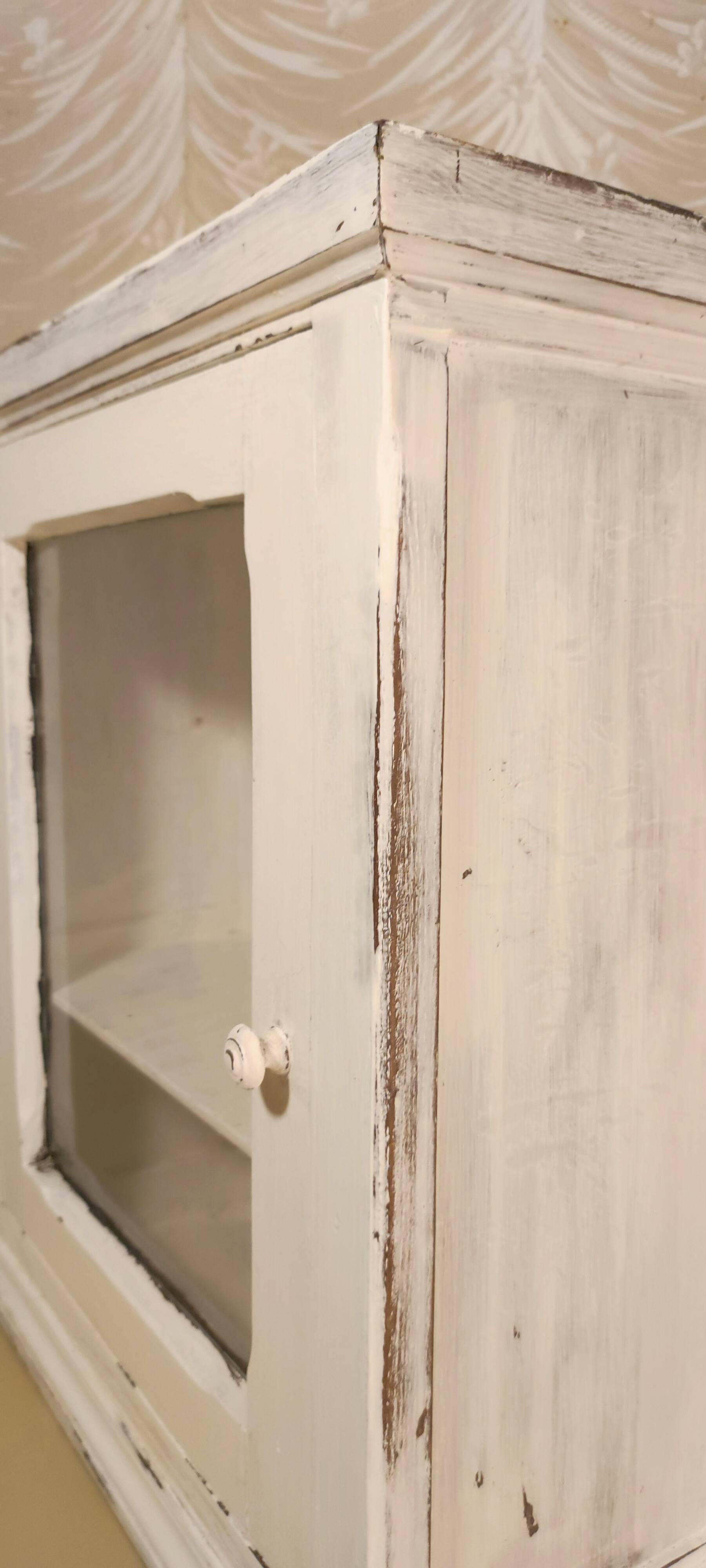 Glazed wall-mounted medicine cabinet in patinated wood