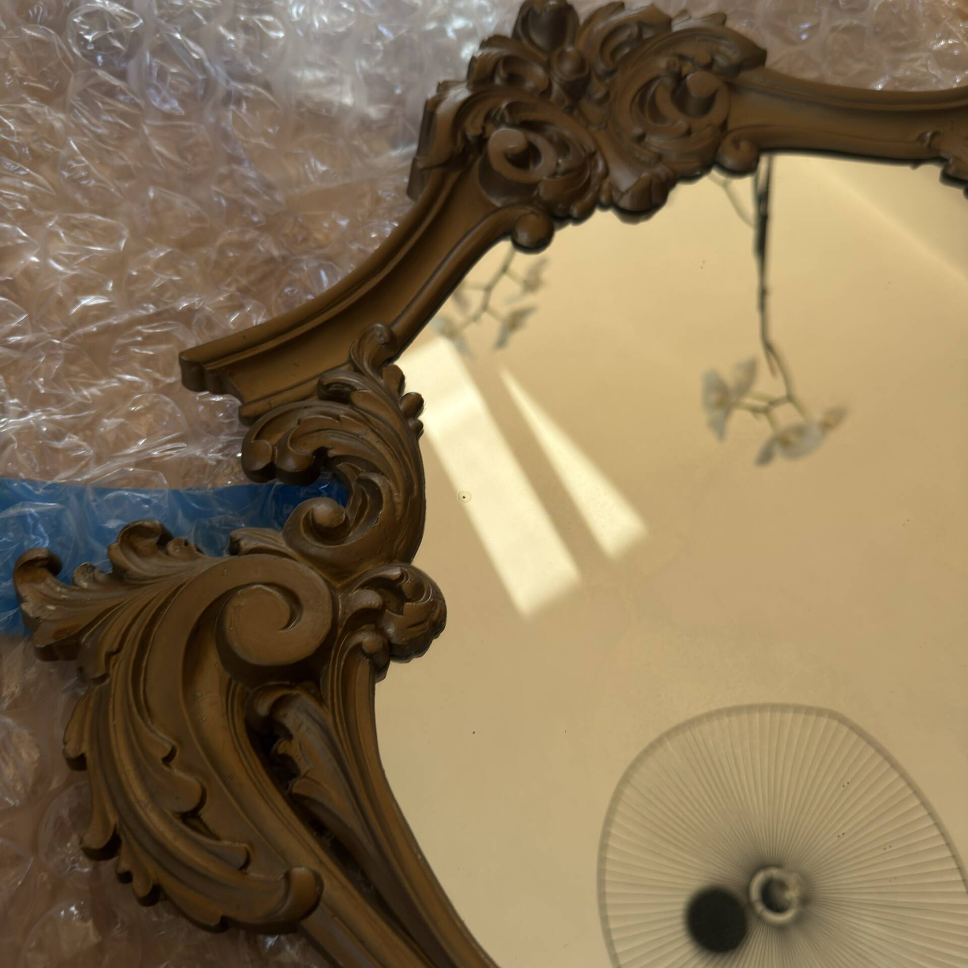Antique mirror in Louis XV Rocaille style with carved frame.