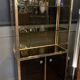 Hollywood Regency style bookcase shelf, gilded brass and black lacquered wood, 1970