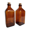 Two pharmacy bottles in amber molded glass 1 liter