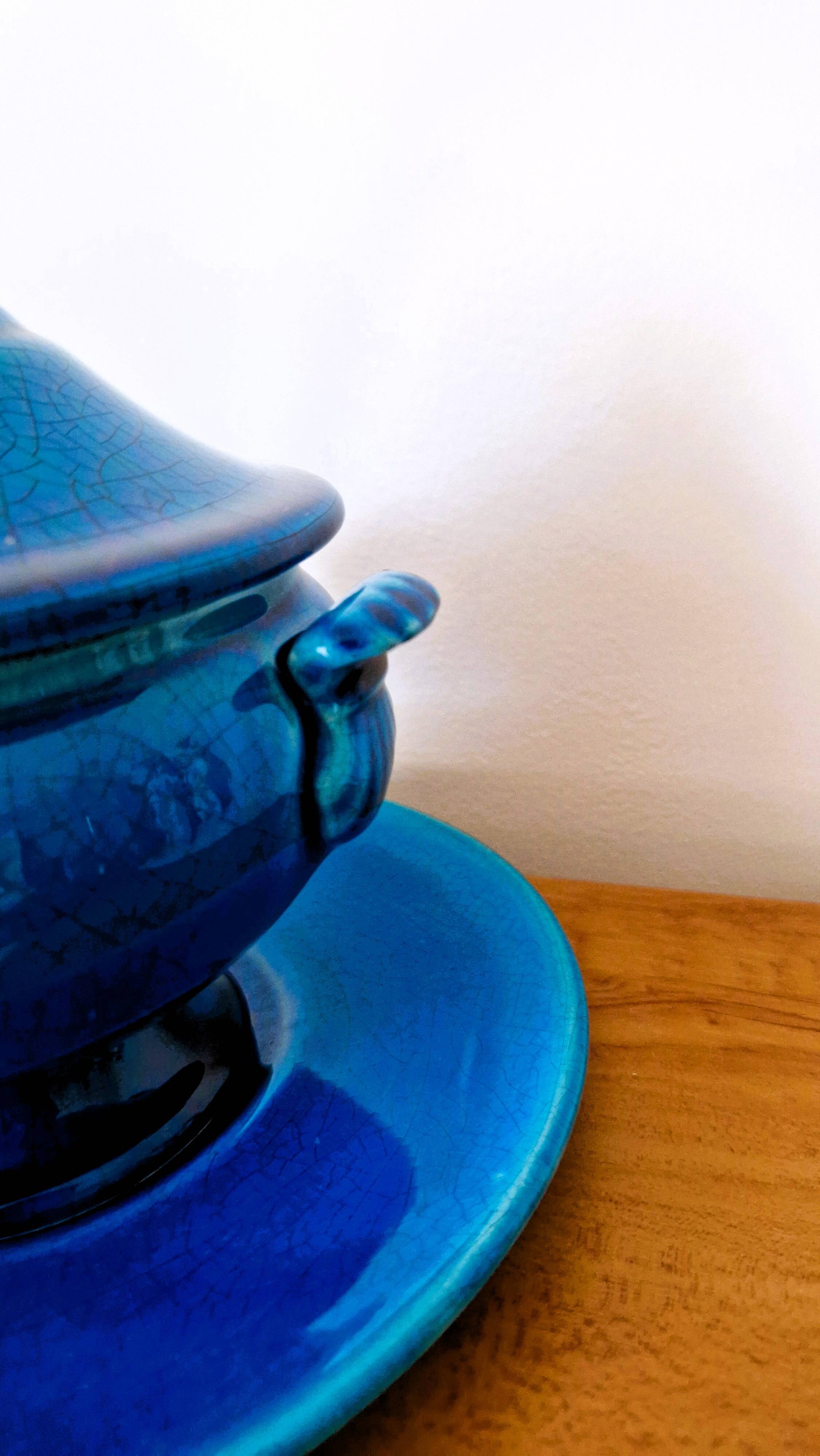 Blue ceramic soup tureen and crackled finish trivet.