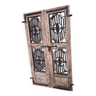 Chiseled teak door with openwork wrought iron panels