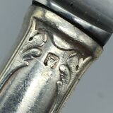 12 silver metal knives.