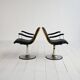 Pair of European 1970s swivel armchairs in faux leather and steel