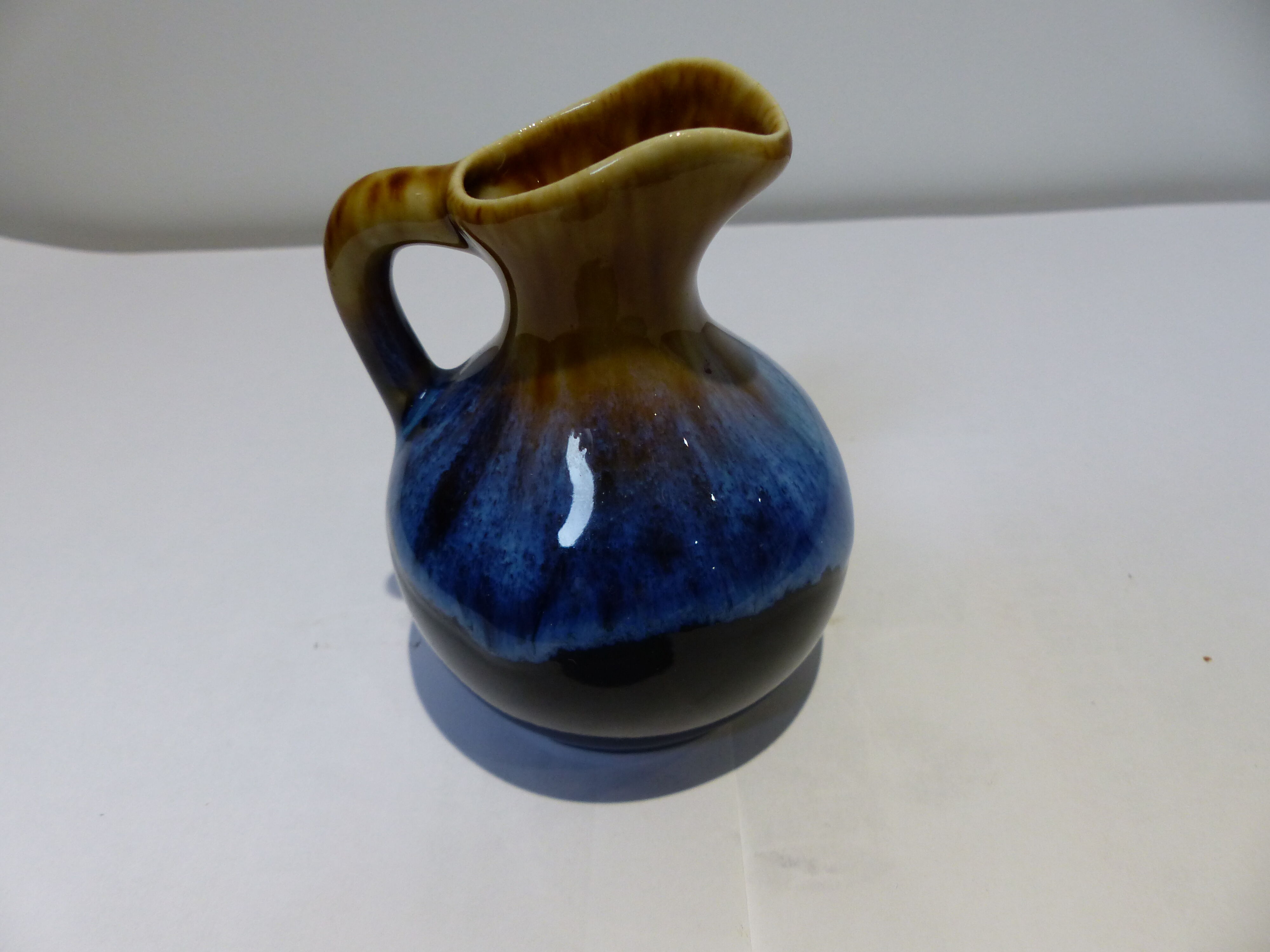 Small vintage ceramic pitcher Blue and brown black reflections