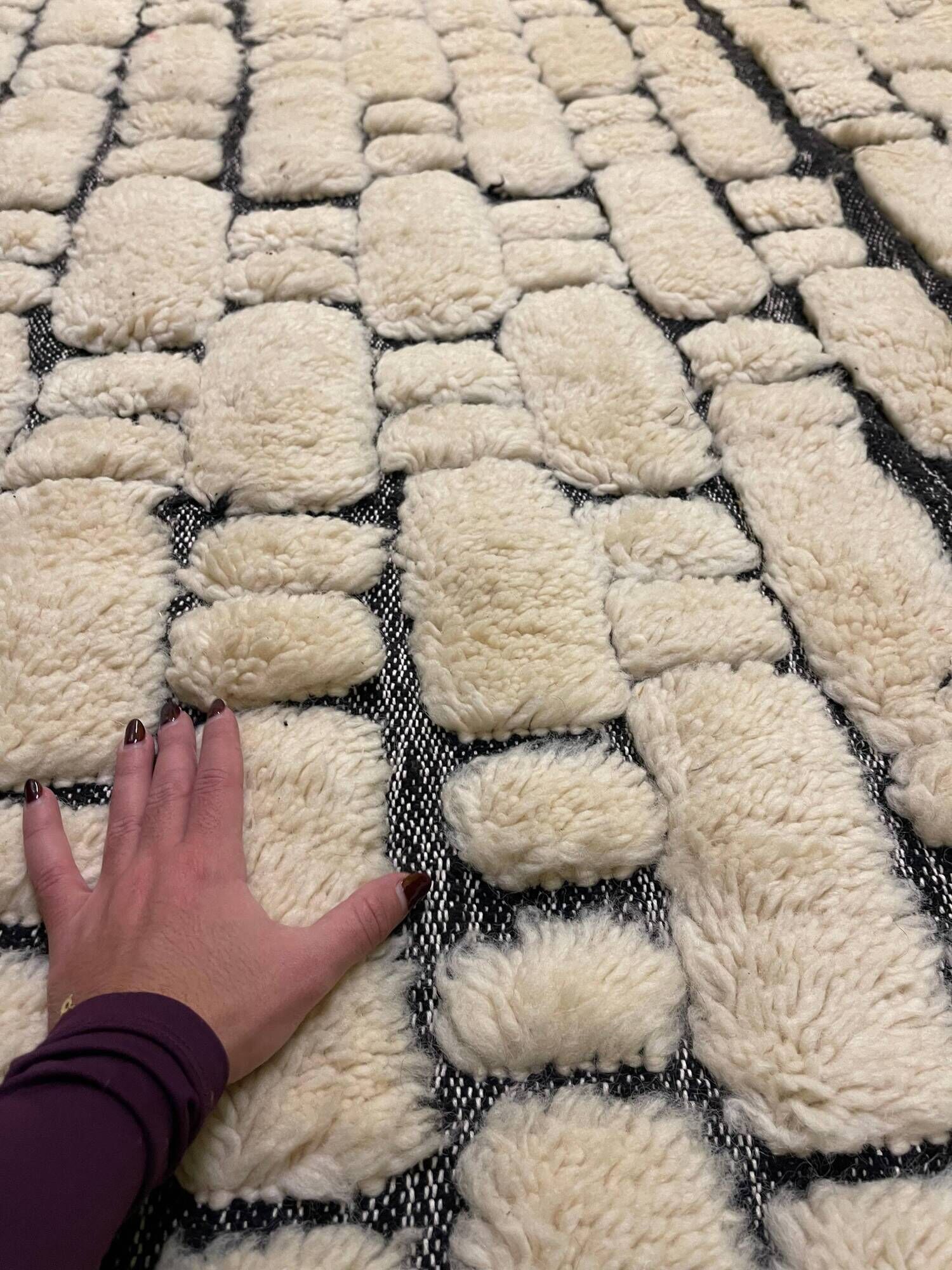 Large cream and black checked Berber rug, 280 × 200 cm.