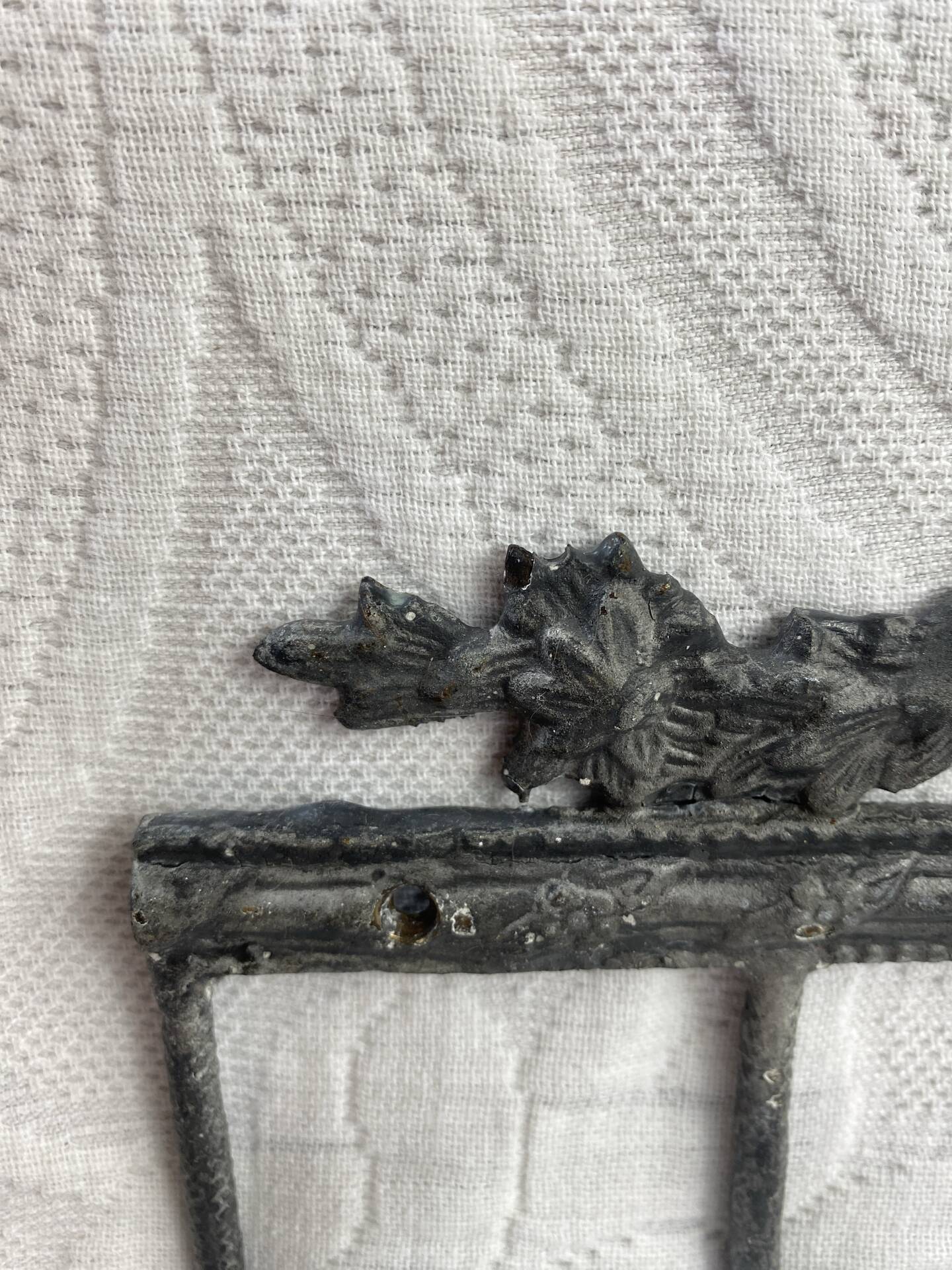 Patinated metal wall bracket and porcelain