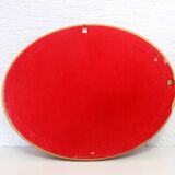 Golden oval mirror with leaf